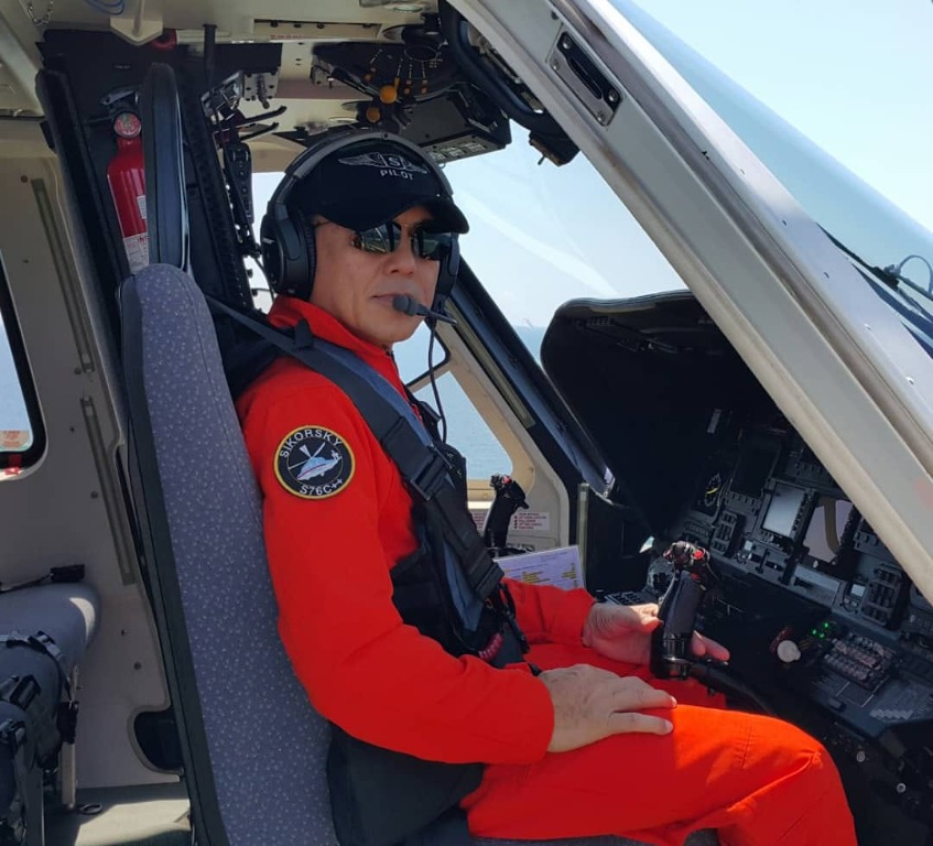 Capt. Naru Kiob, CEO of NK Robotics, in a helicopter cockpit